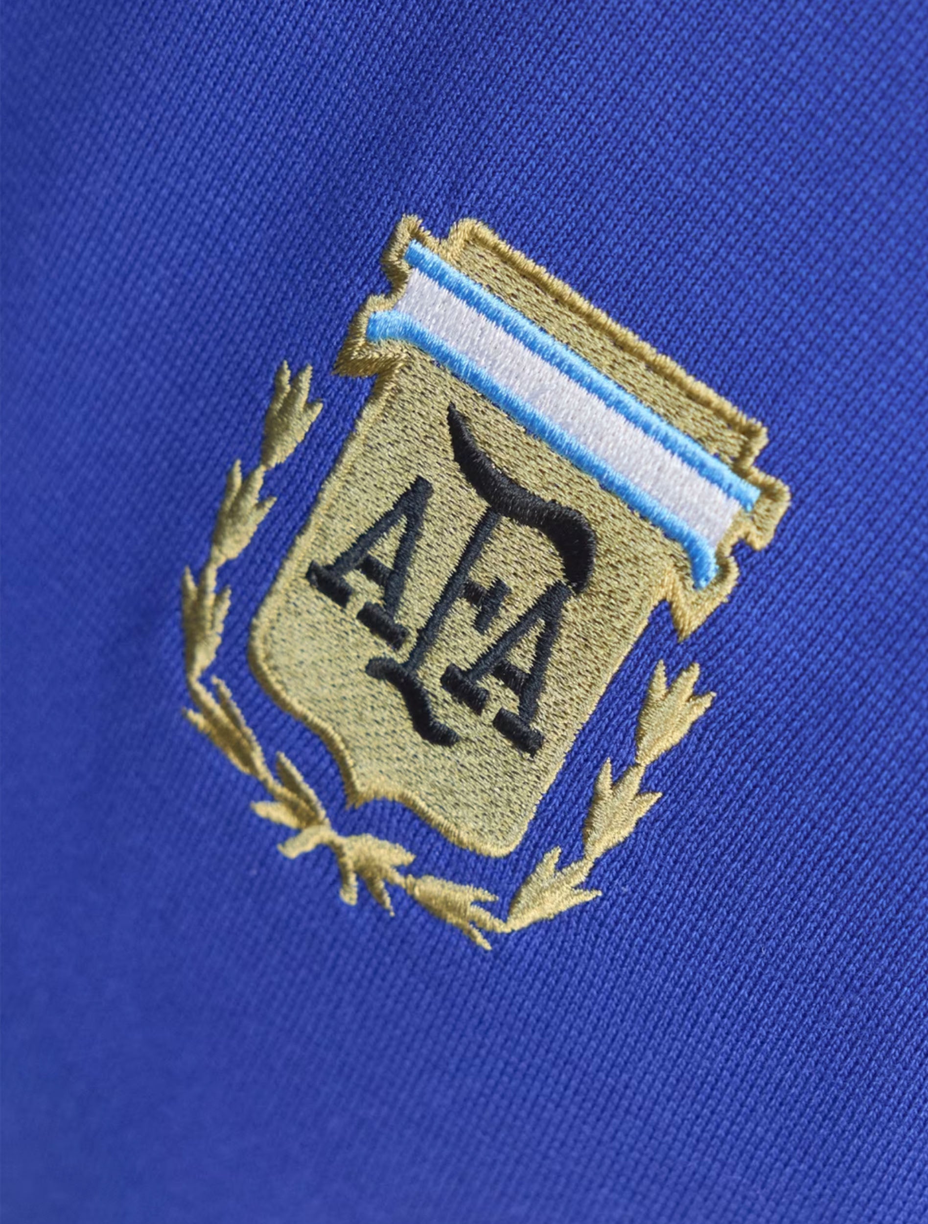 AFA crest embroidery detail on Adidas Argentina Originals Tee in Lucid Blue