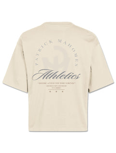 Back of the ivory boxy tee with PATRICK MAHOMES arched over Athletics script and Dedicated to the Grind