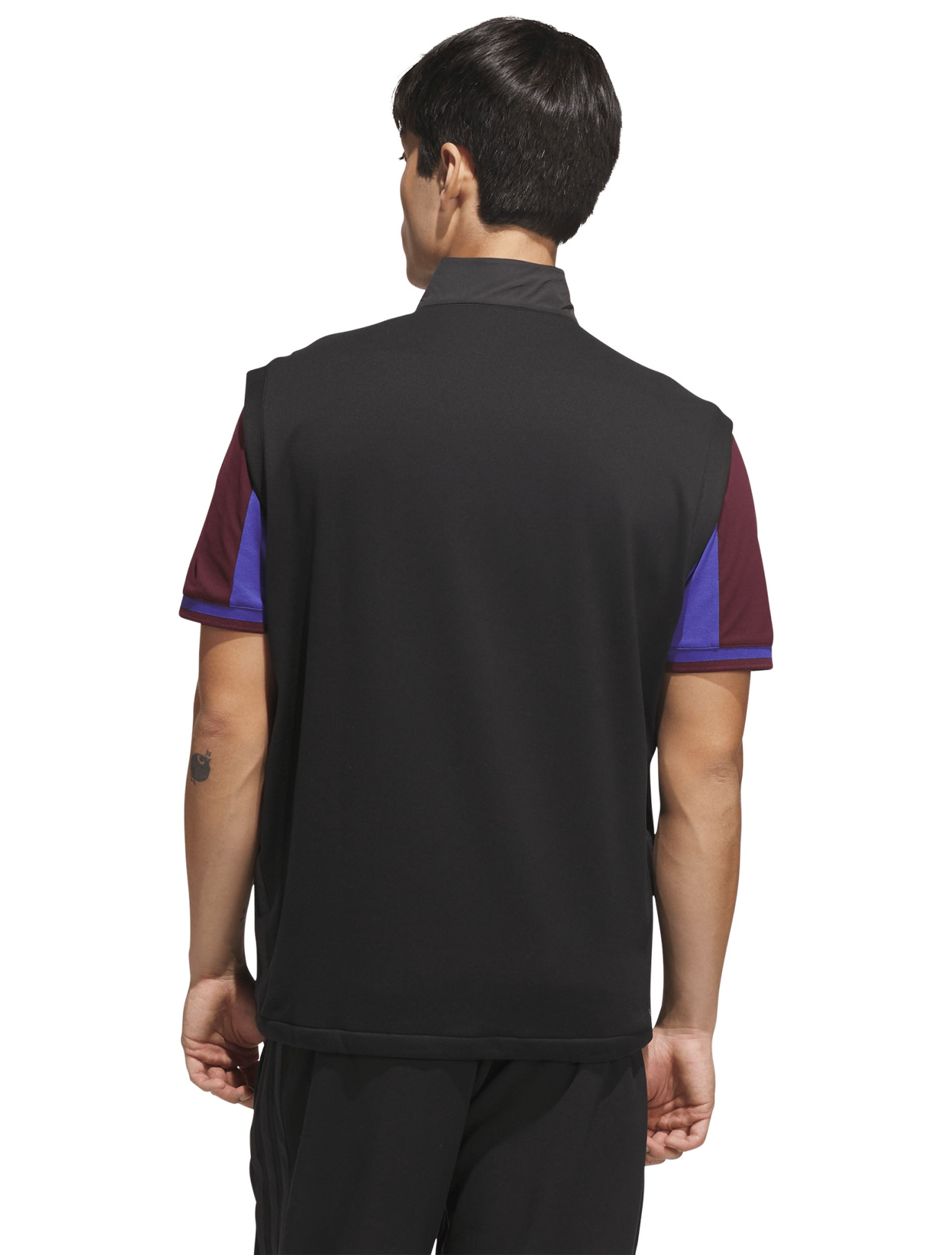 Back of the black golf vest showing the soft knit back panel