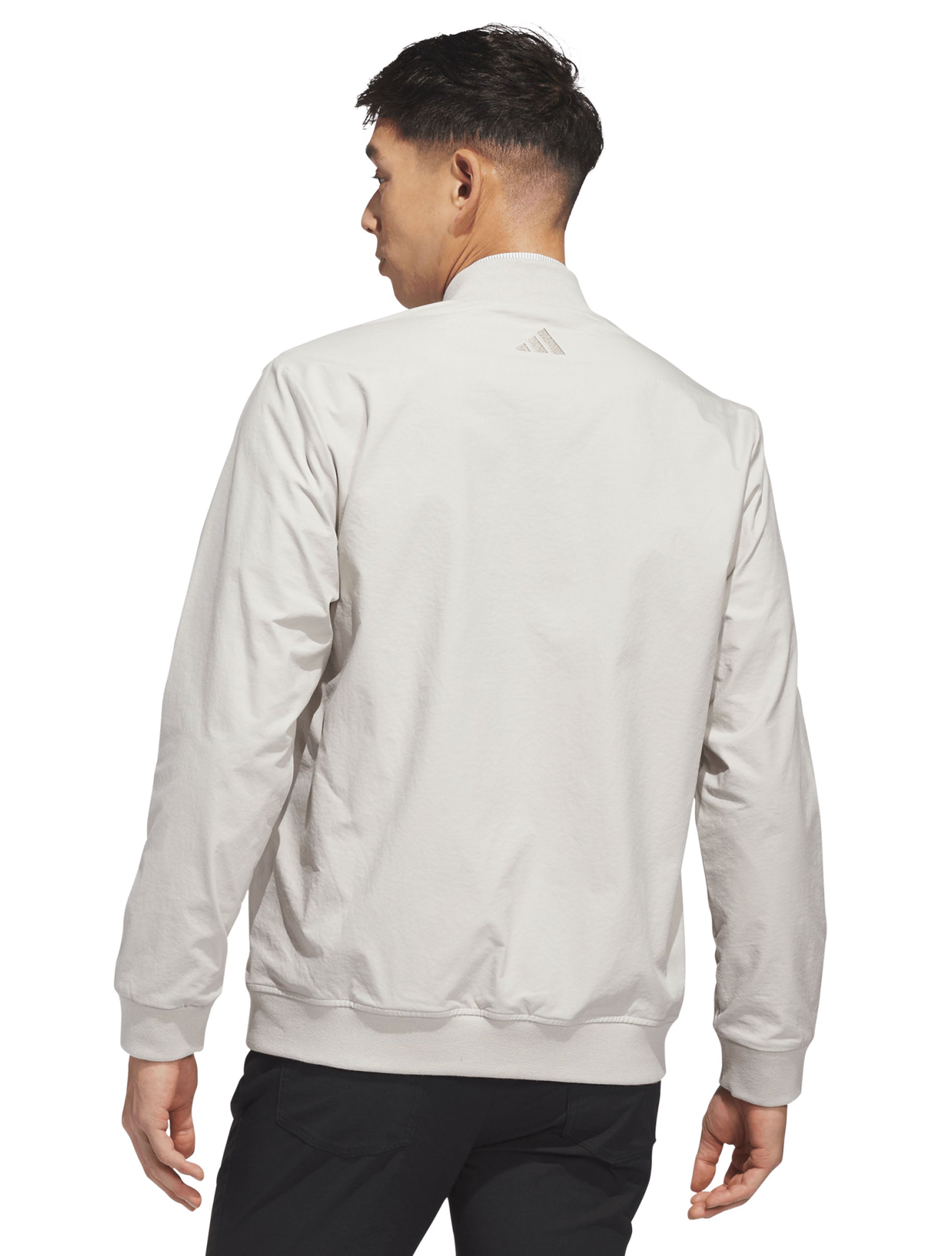 Model wearing the silver Adidas Texas Tech golf full zip bomber jacket, back view