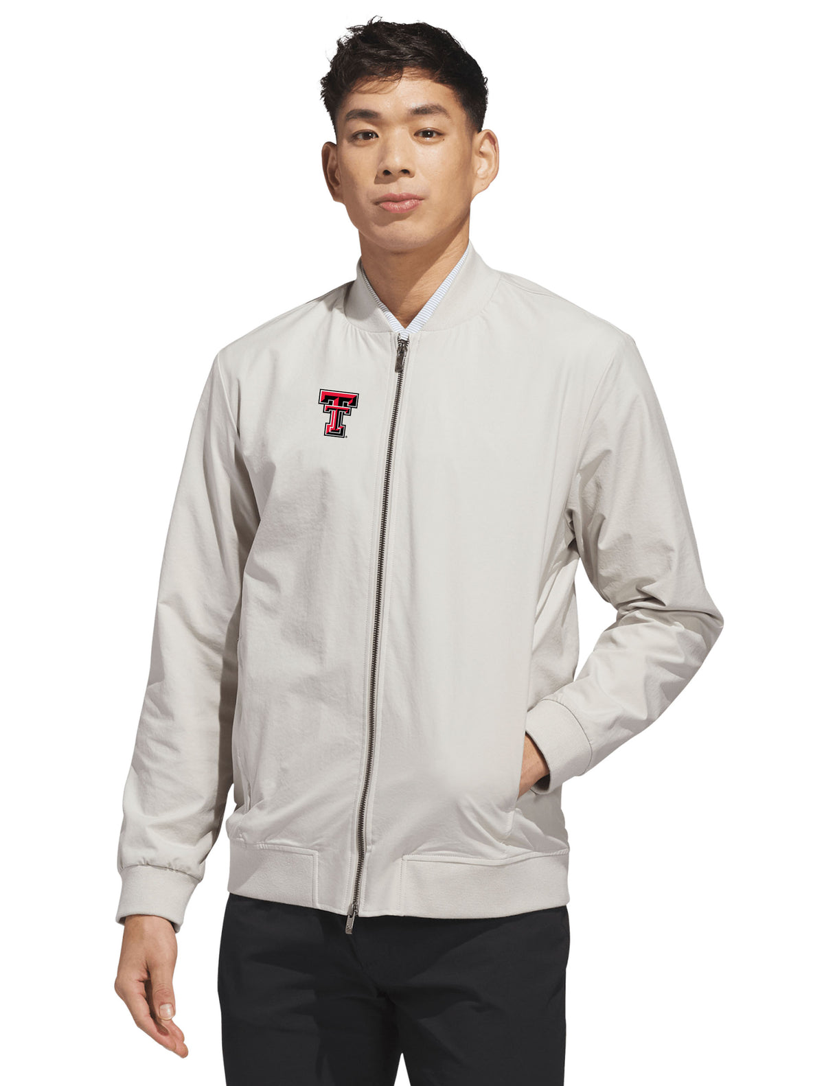 Model wearing the silver Adidas Texas Tech golf full zip bomber jacket, front view
