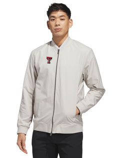 Model wearing the silver Adidas Texas Tech golf full zip bomber jacket, front view