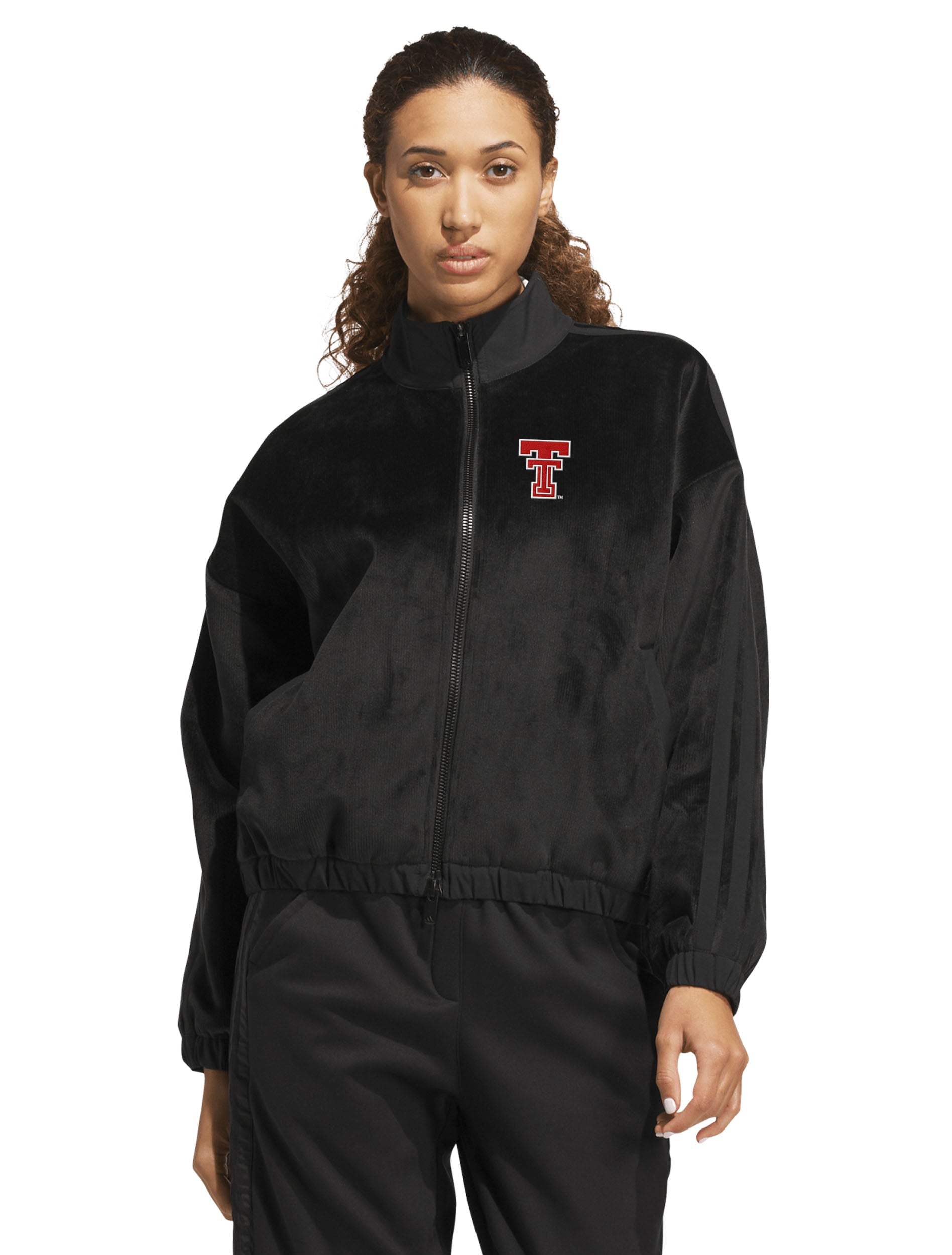 Model wearing the black Adidas women's velvet bomber jacket, front view