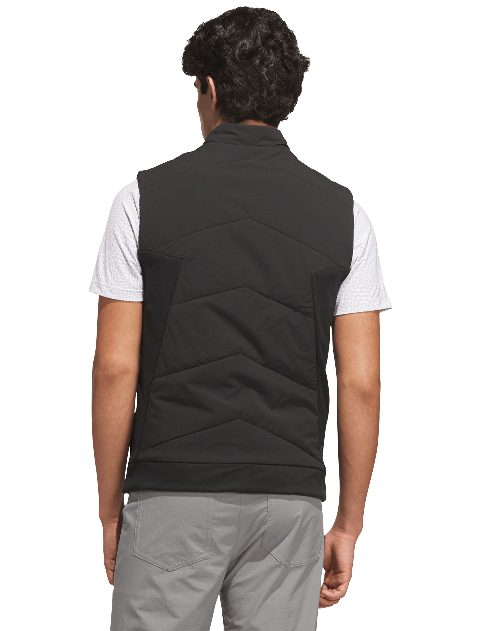 Back of the black quilted golf vest showing chevron quilting and stretch knit side panels