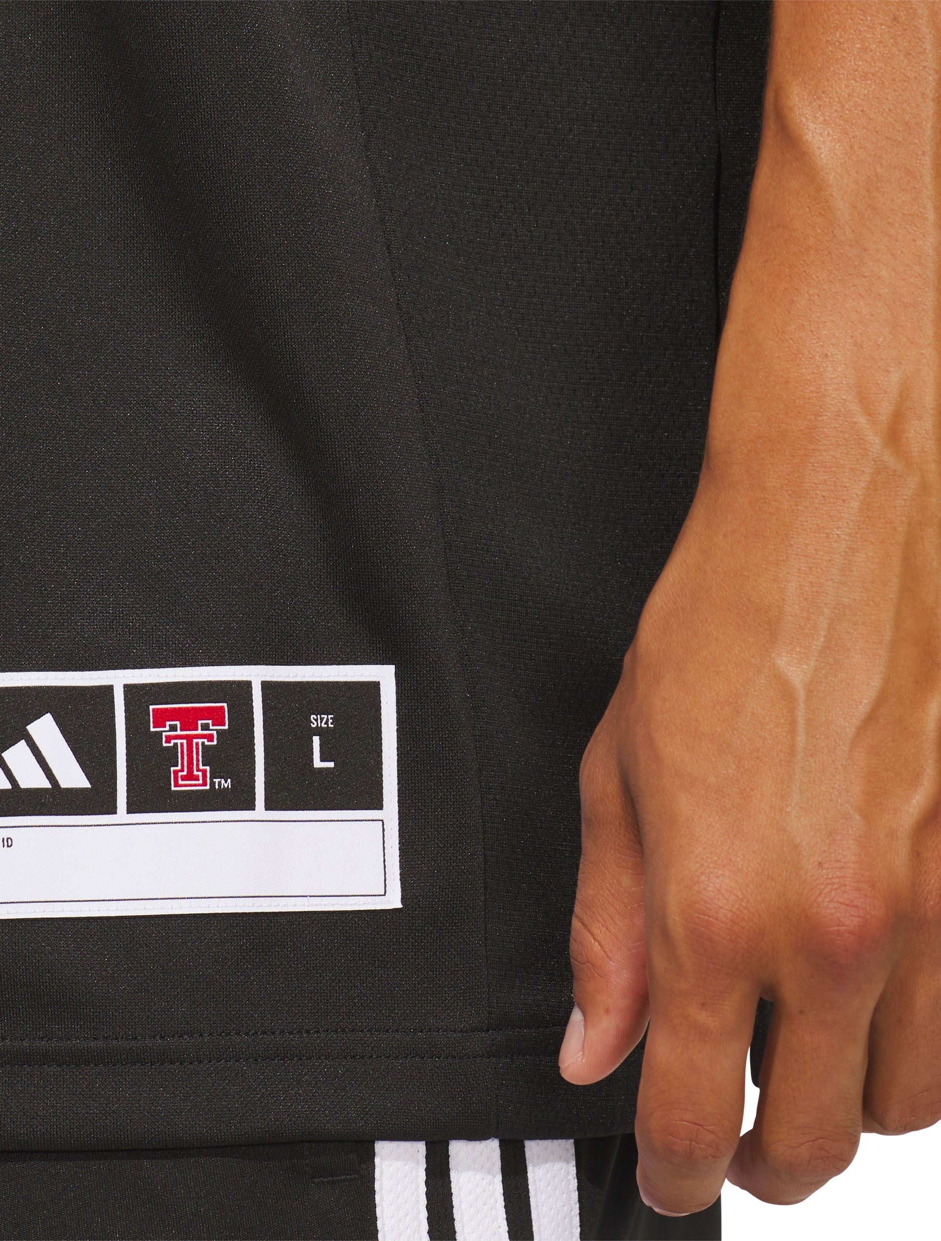 Full length view of a model wearing the black Texas Tech Mahomes jersey with black shorts
