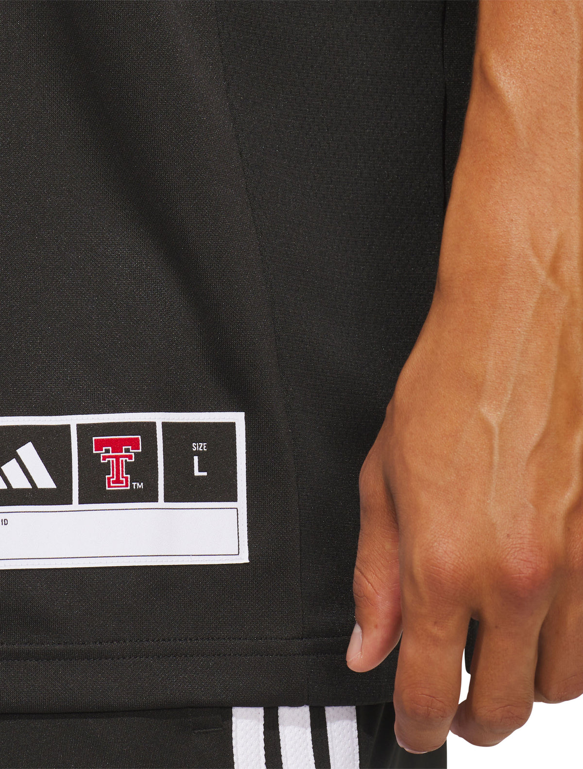 Full length view of a model wearing the black Texas Tech Mahomes jersey with black shorts