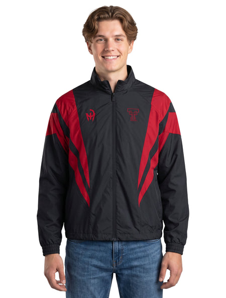 Model wearing the black Texas Tech track jacket with red chevron panels, zipped over a tee and styled with denim