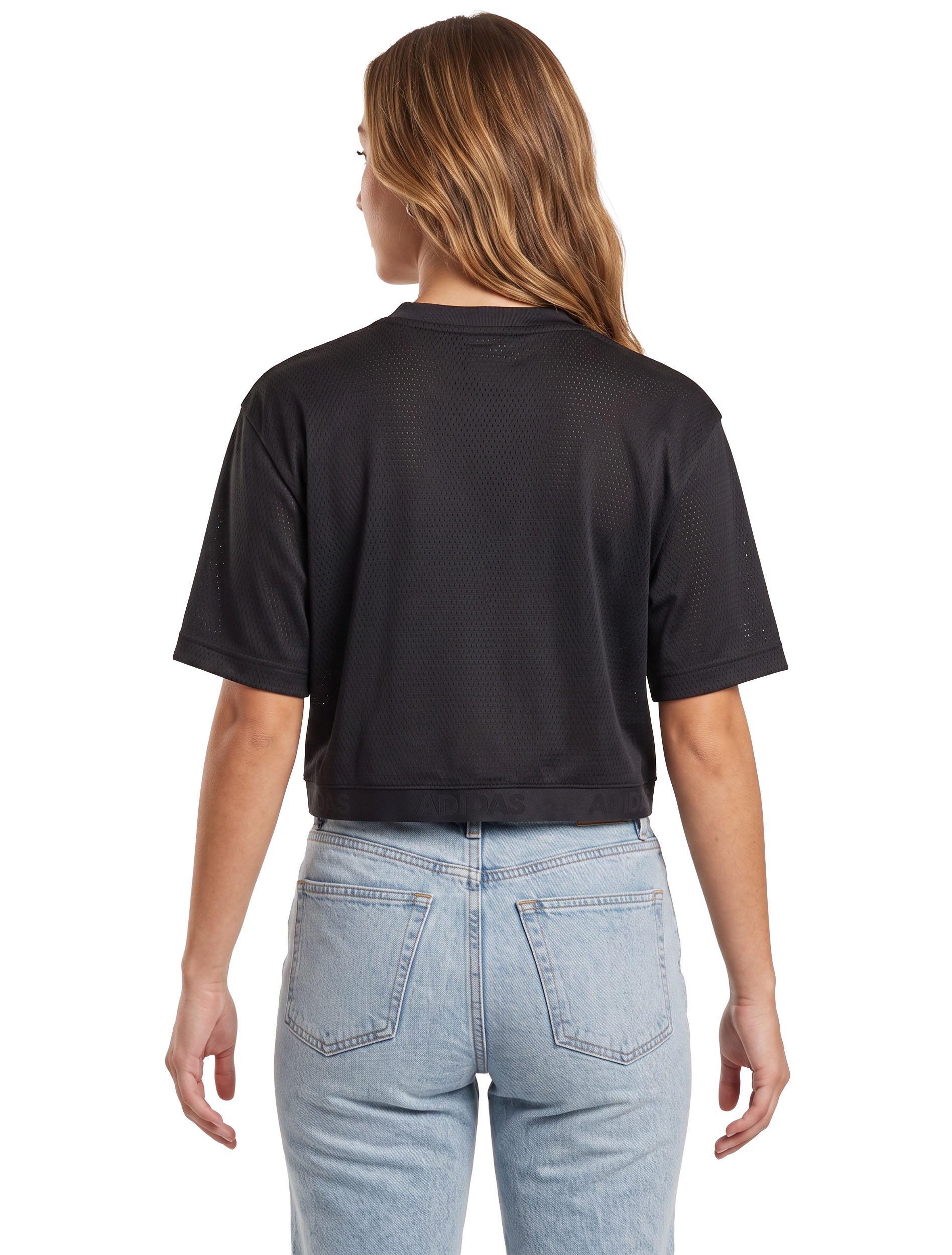 Model wearing the black Texas Tech mesh crop jersey, back view showing the plain back and the adidas elastic hem band