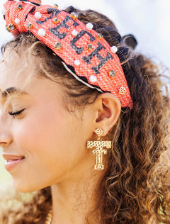 Profile view of a model wearing the red Texas Tech “Wreck ’Em Tech” cross stitch headband