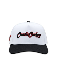 Front of the white cap with a black brim and Classic Cowboy embroidered in black script with red detailing