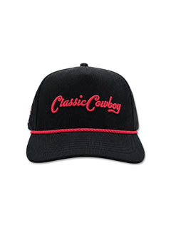 Front of the black corduroy cap with Classic Cowboy embroidered in red script above the red rope