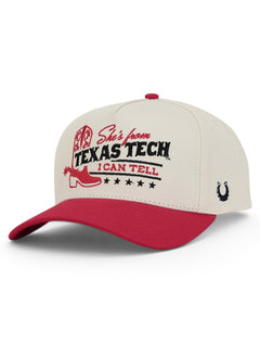 Tan Texas Tech snapback cap at an angle, with a red cowboy boot and She's from Texas Tech across the front