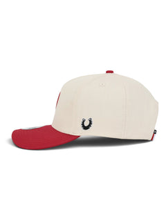 Left side of the cream youth Texas Tech cap showing the Dark Horse horseshoe on the side panel