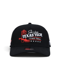 Front of the black youth Texas Tech cap showing a red cowboy boot and spur beside She's from Texas Tech, I Can Tell in white with red rules and five white stars beneath