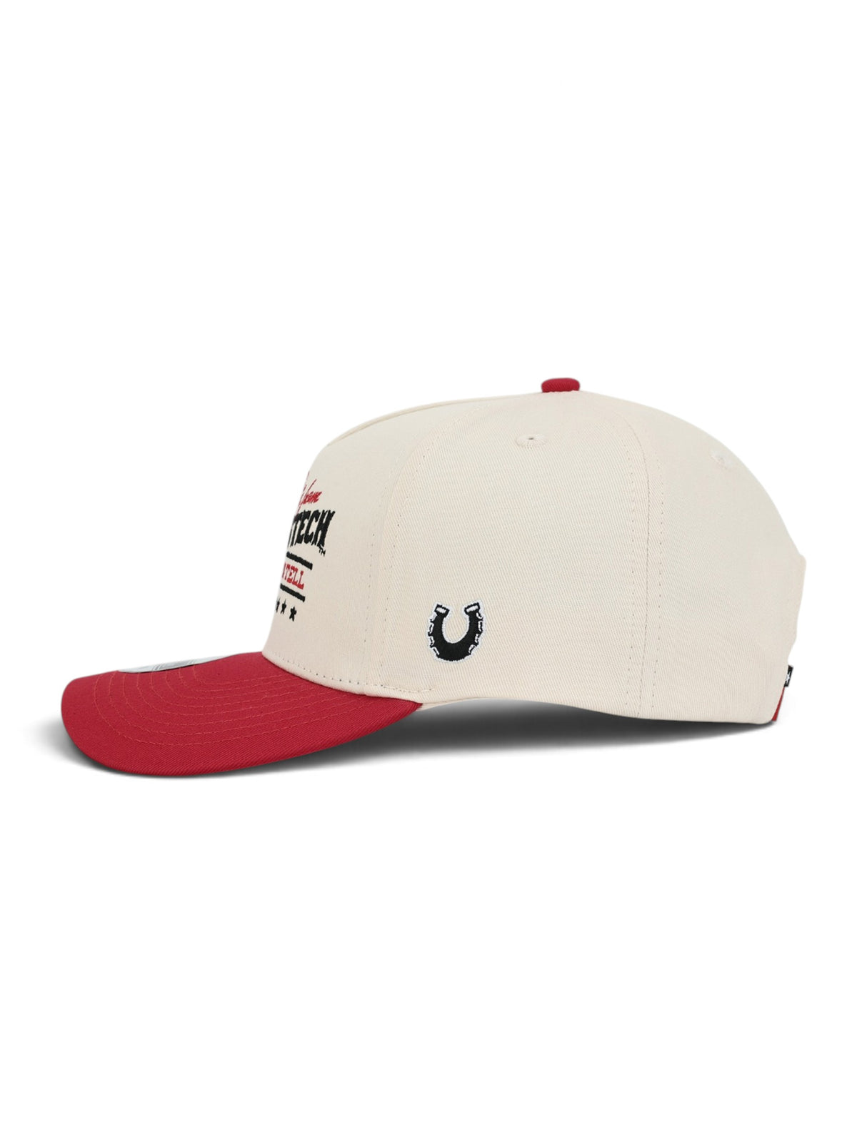Left side of the cream youth Texas Tech cap showing the Dark Horse horseshoe on the side panel above the red brim