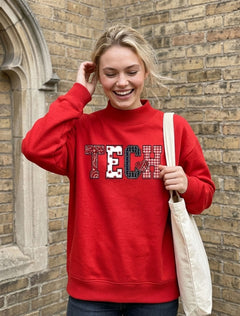 Model wearing the red Dark Horse Texas Tech “Tech Pattern” Mock Neck with TECH across the chest in four mixed patterns