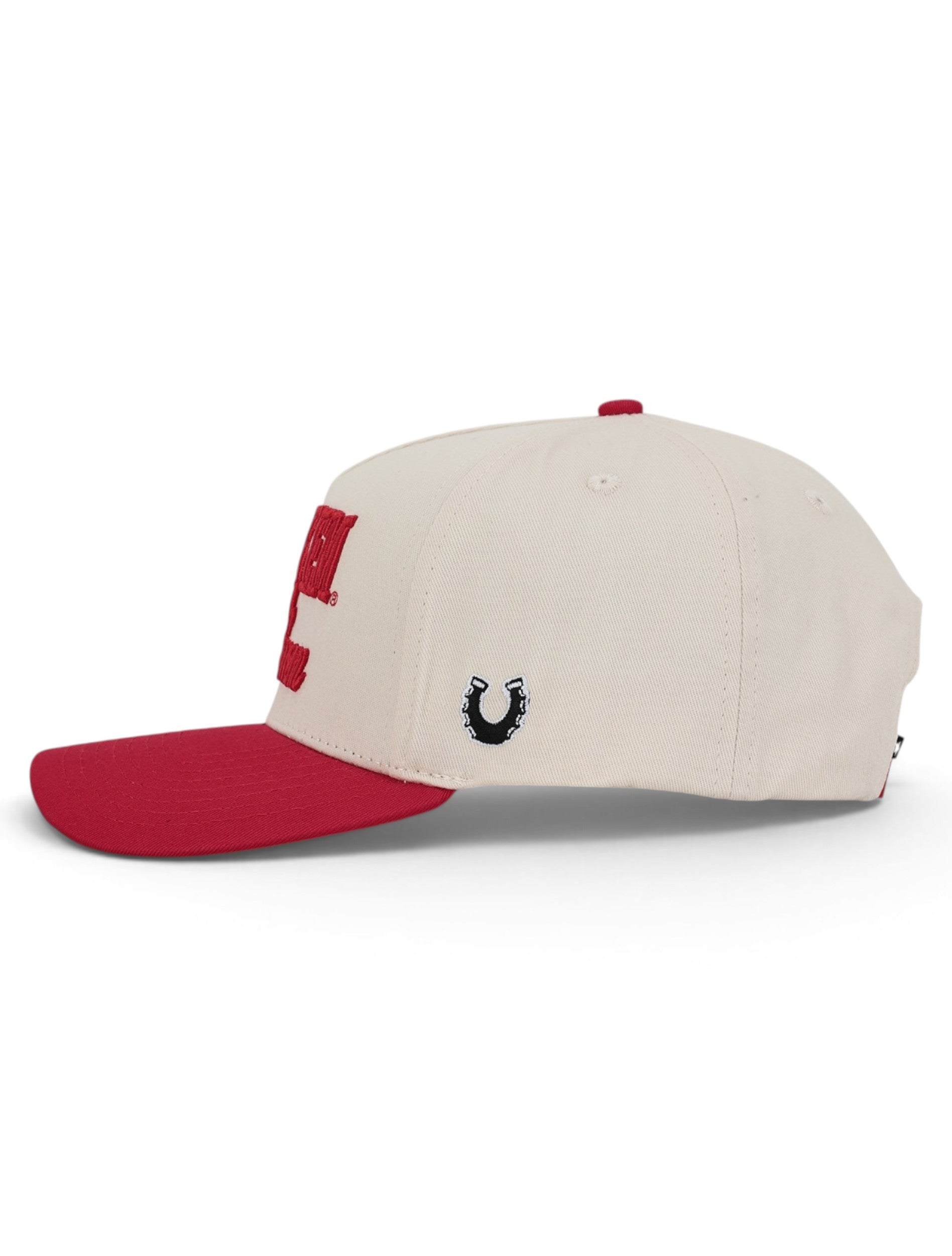 Side of the tan Texas Tech cap showing the Dark Horse horseshoe on the panel