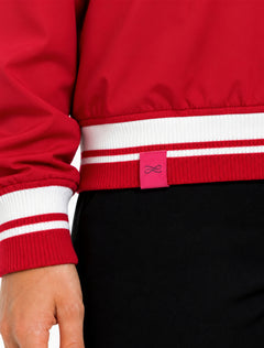 Close-up of the striped ribbed hem and cuff with the pink Lusso tab