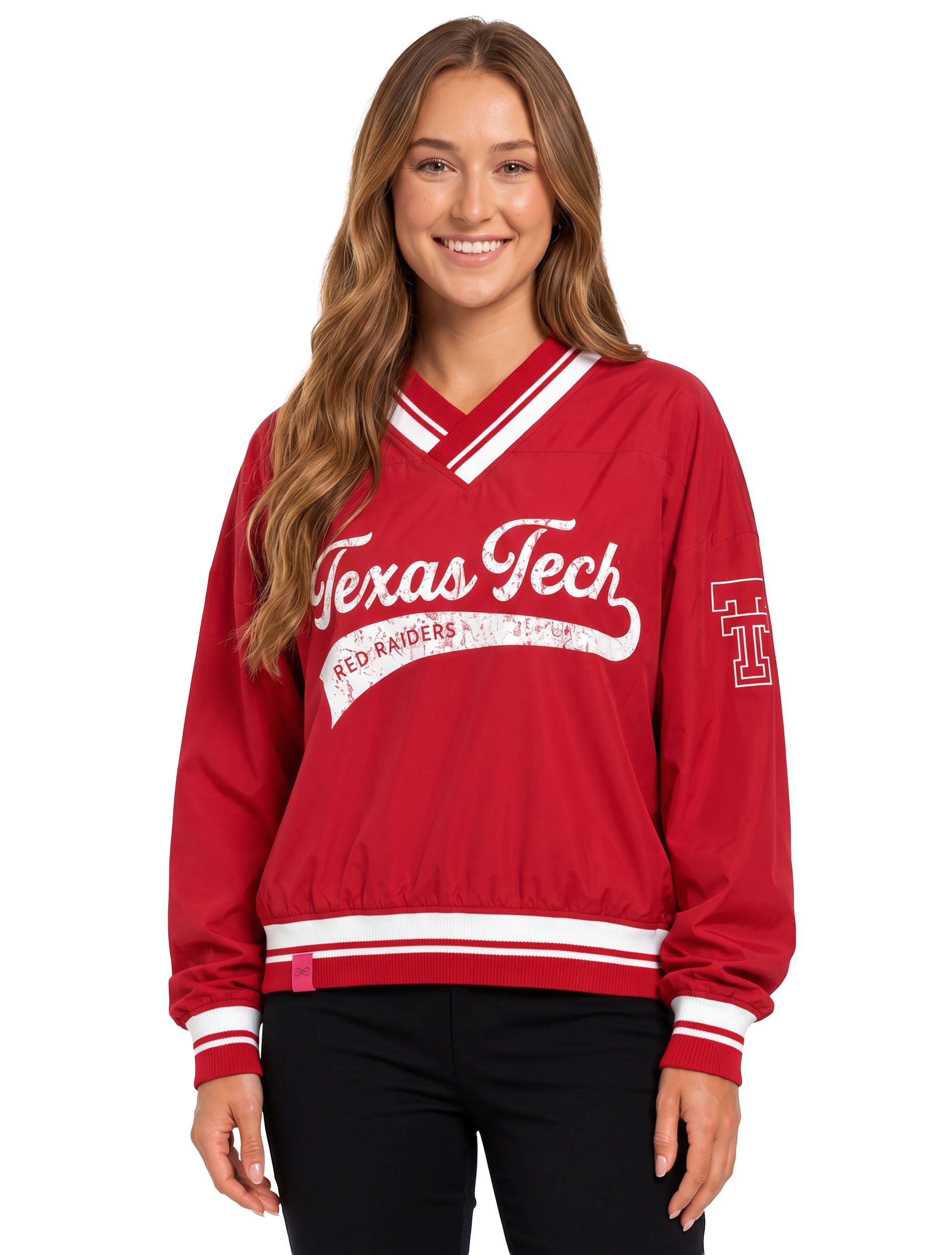 Model wearing a red Lusso V-neck pullover with distressed white Texas Tech script and RED RAIDERS across the chest