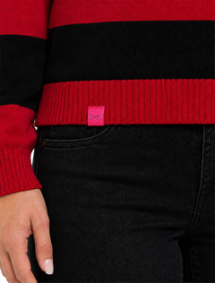 Close up of the red ribbed hem on the Lusso Texas Tech Silvia striped polo with the pink Lusso tag