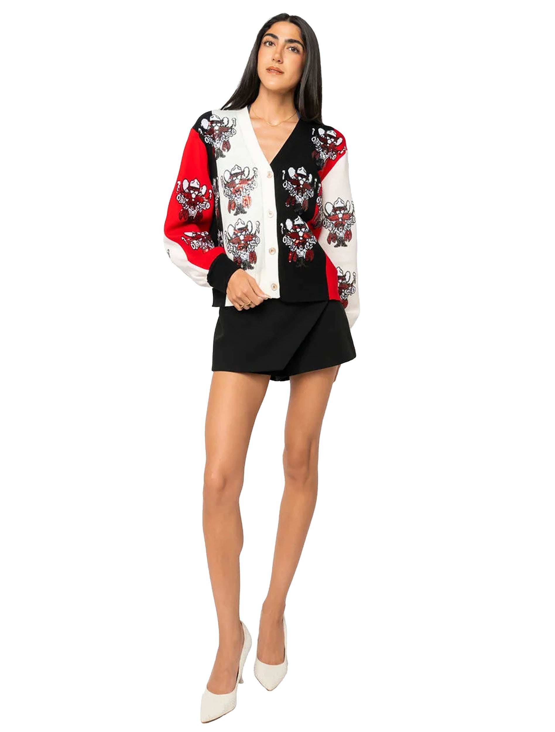 Full length view of the cardigan worn open over a black skort