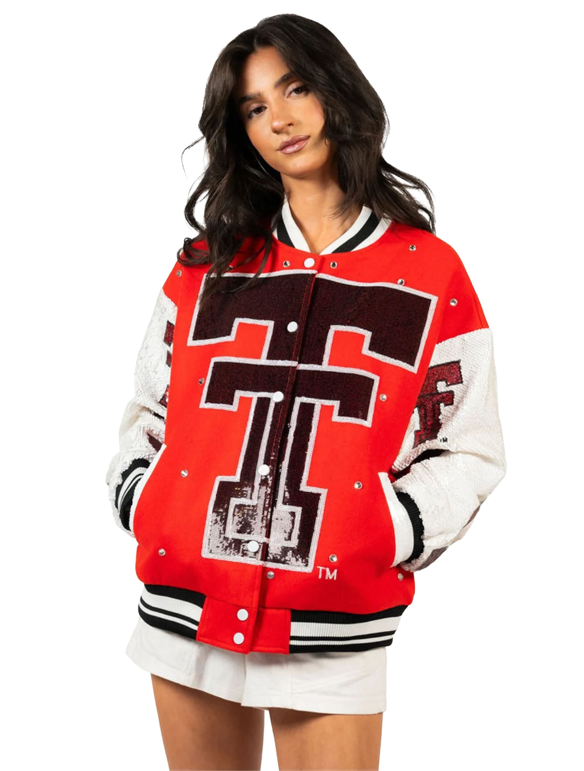 Close view of the red bomber jacket showing the sequin throwback Double T, silver snap front, and black and white striped ribbed collar and hem