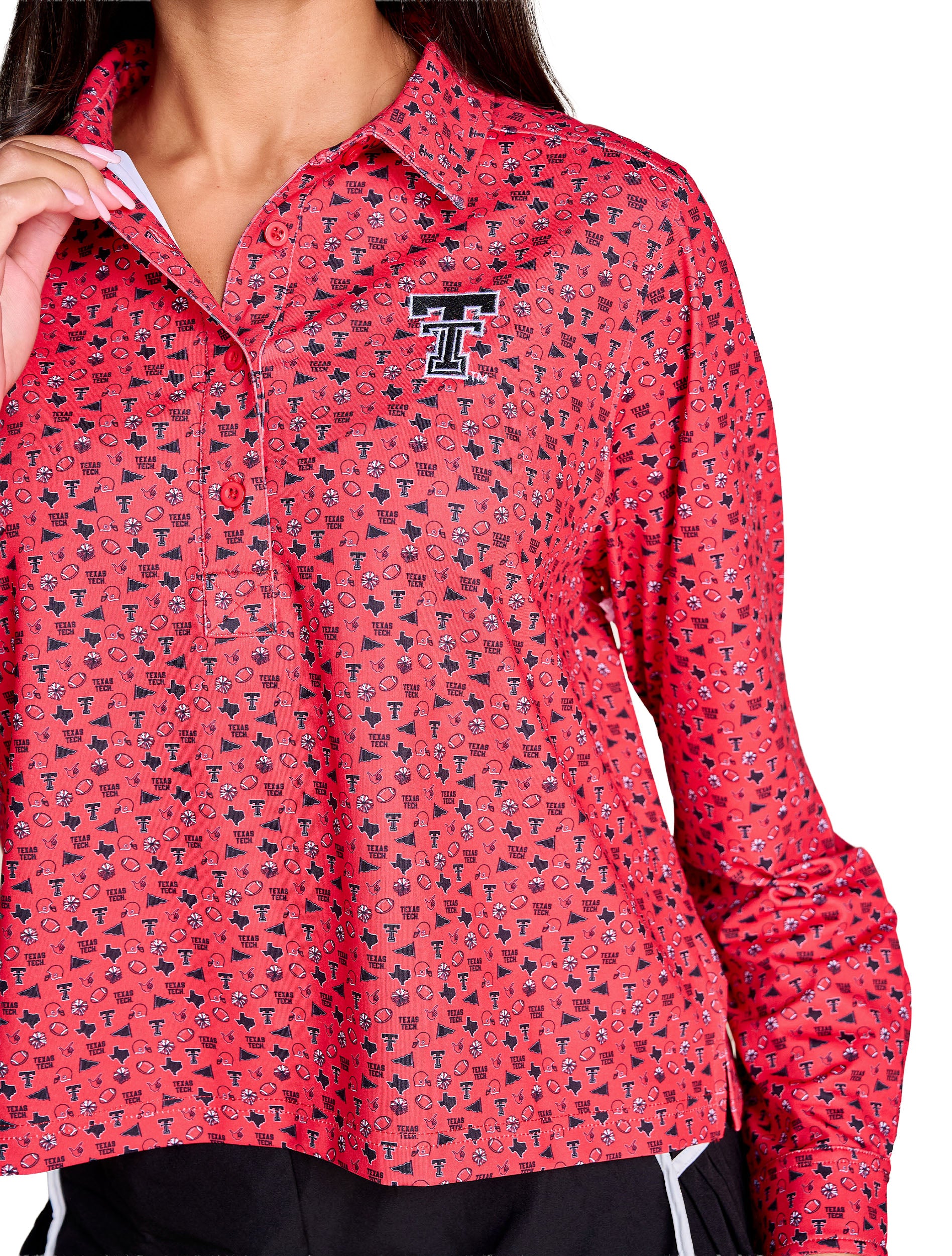 Close up of the all over print showing footballs, helmets, megaphones, pom poms and the state of Texas, with the embroidered black Double T at the left chest