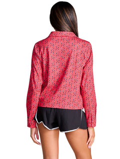 Back of the red all over print Texas Tech long sleeve polo, showing the collar, the shoulder seams and the curved hem