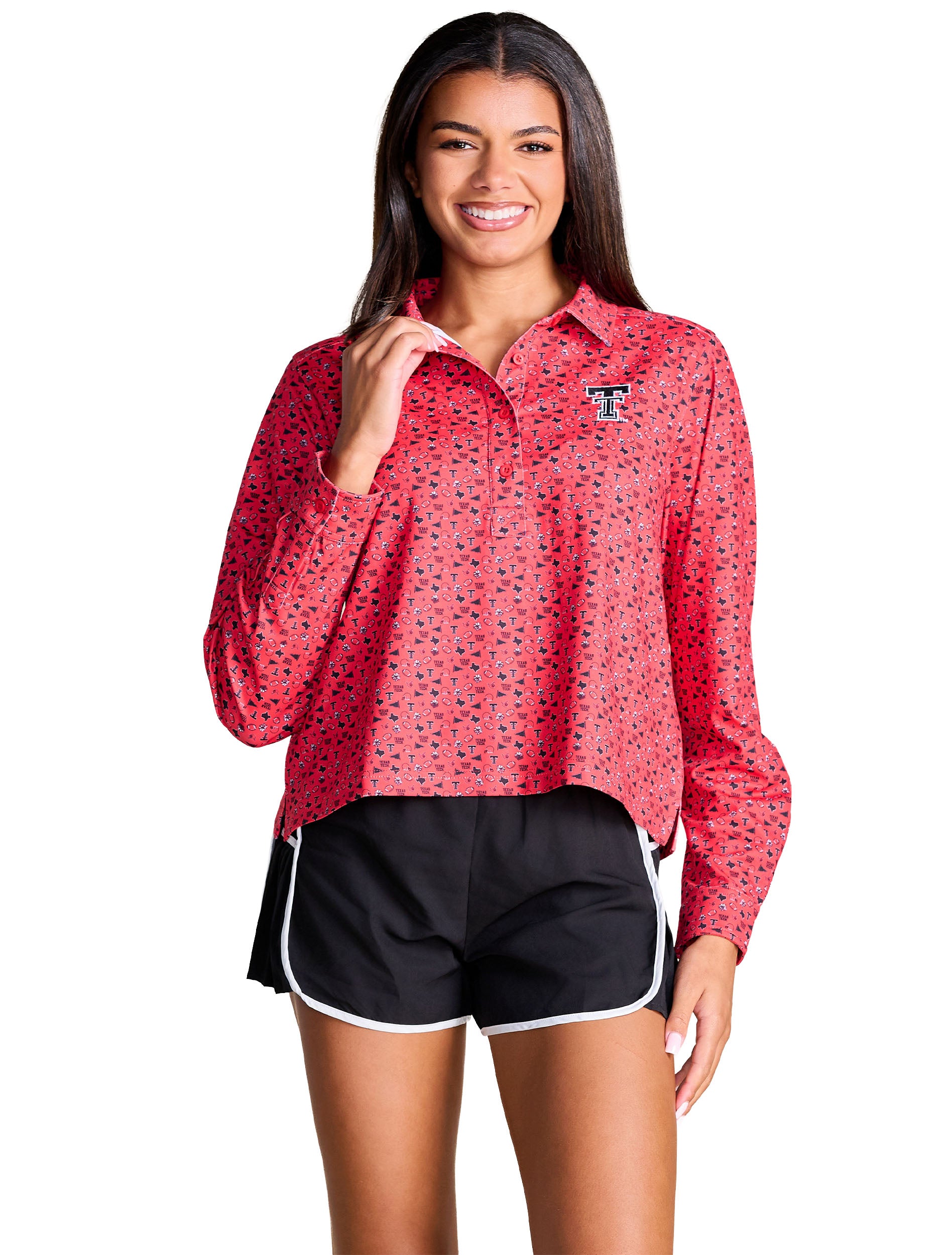 Model wearing the red all over print Texas Tech long sleeve polo with a spread collar, styled with black running shorts