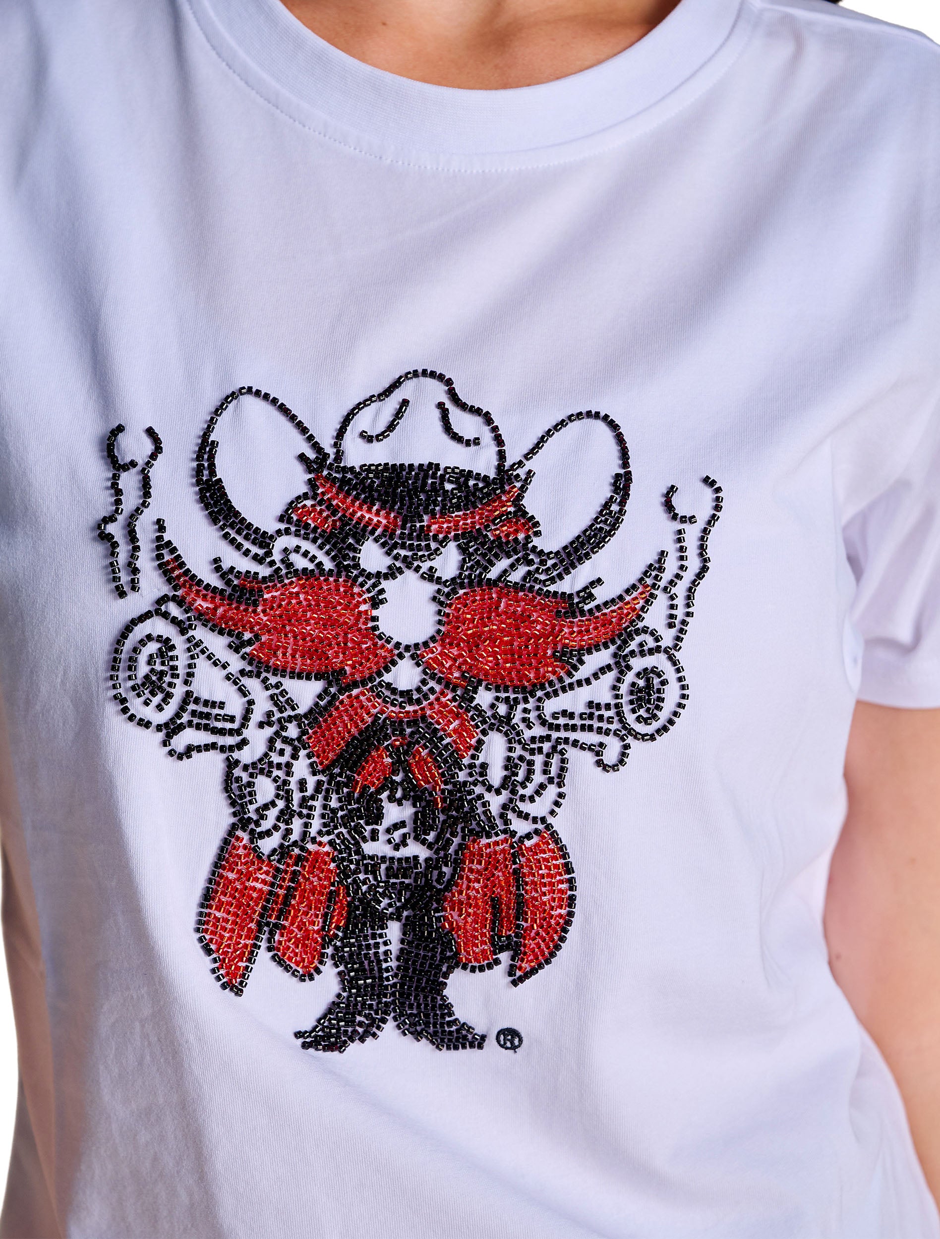 Close up of the red and black beadwork forming Raider Red, showing his cowboy hat, raised pistols, red chaps and black boots