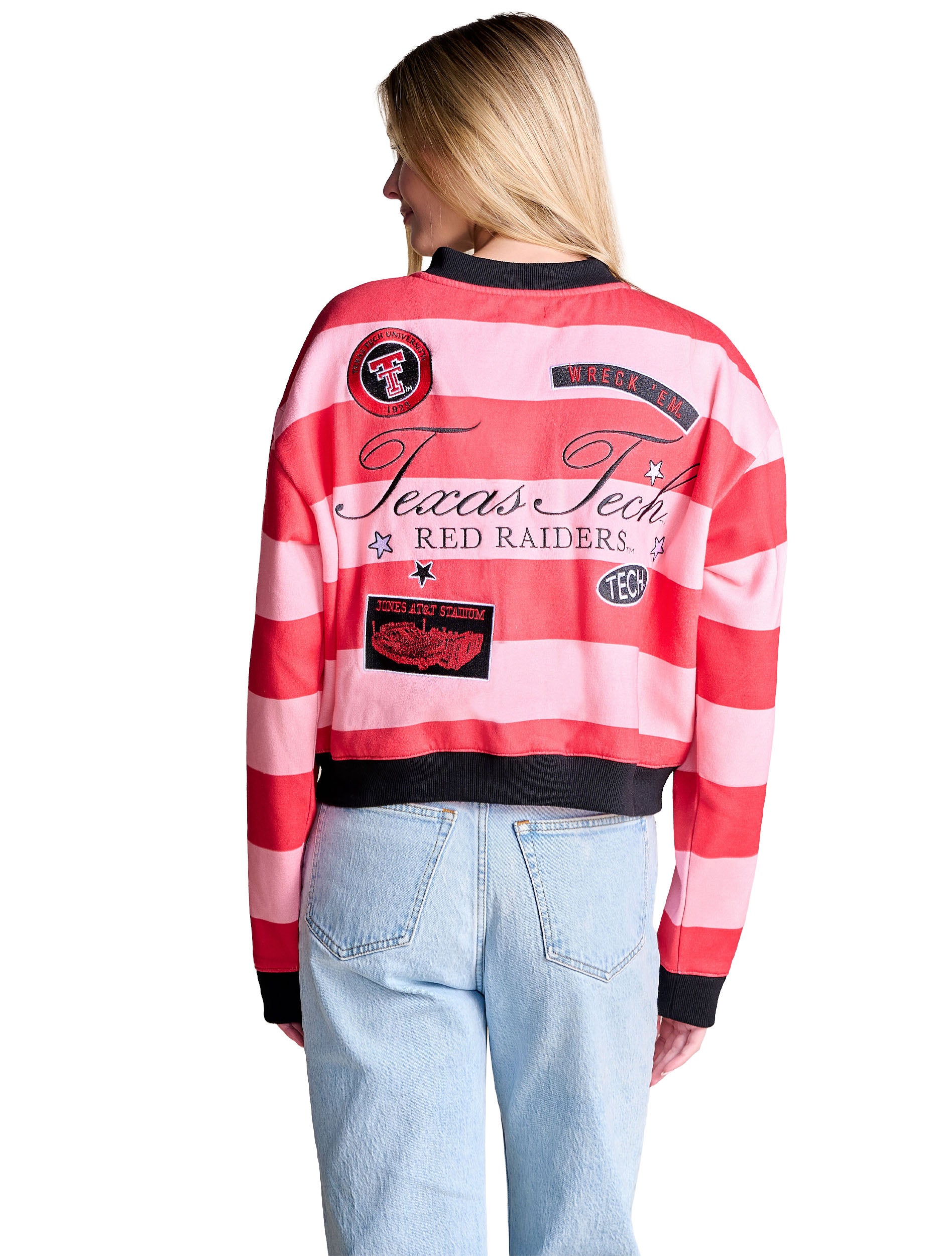 Back of the red and pink striped Texas Tech patch cardigan, showing Texas Tech in script above RED RAIDERS surrounded by patches