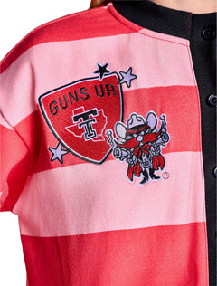 Close up of the front chest embroidery, a GUNS UP shield with the Texas outline and Double T beside Raider Red and lavender stars
