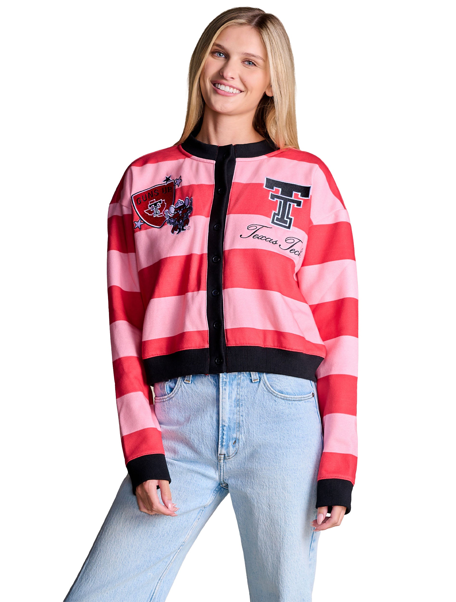 Model wearing the red and pink striped Texas Tech patch cardigan buttoned over light wash denim, with black ribbed collar, cuffs and hem