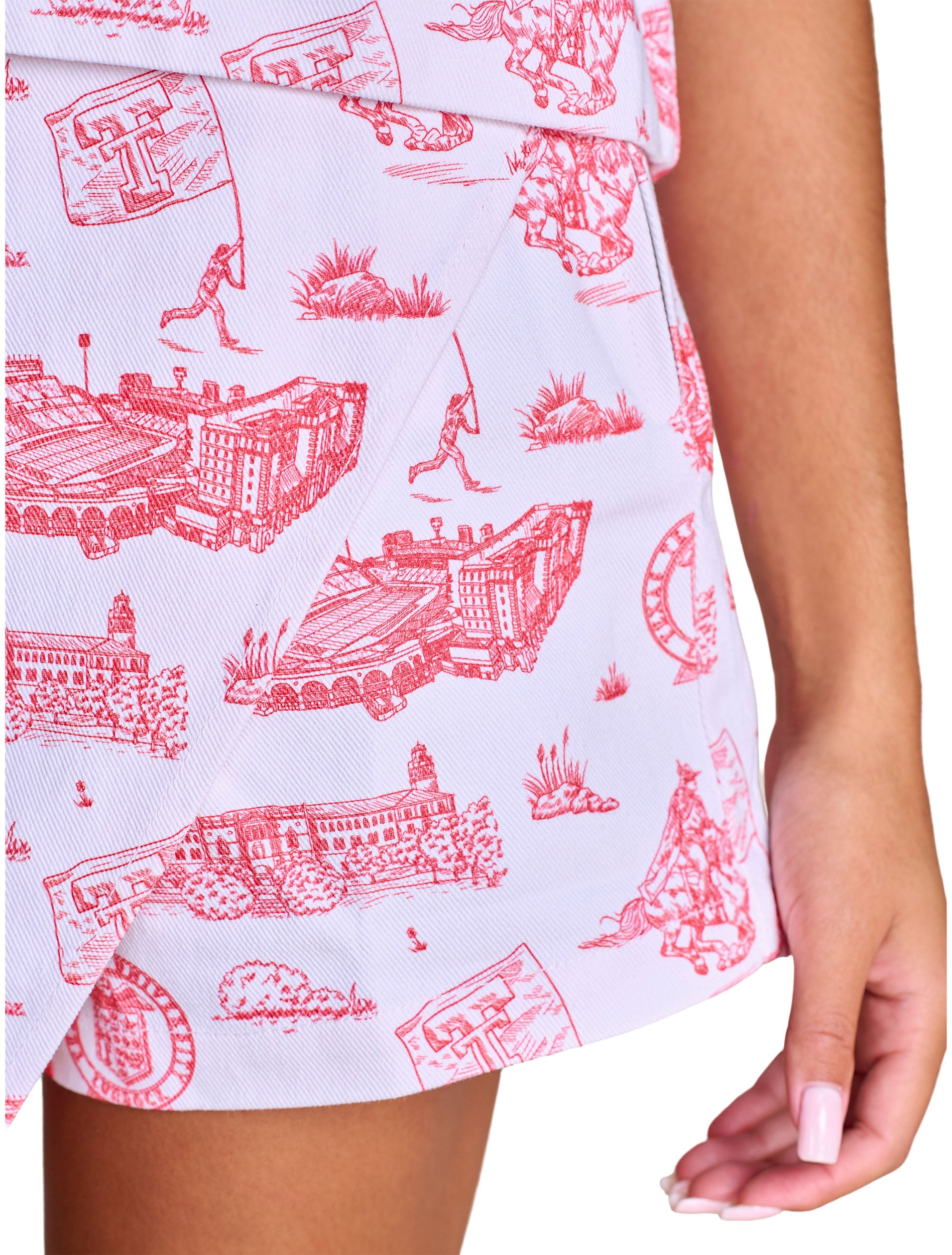 Close up of the red campus toile print on the white denim twill, showing the stadium, the Administration Building and the Masked Rider