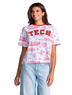 Model wearing the white Stewart Simmons Texas Tech tee with a red campus toile print and embroidered TECH across the chest