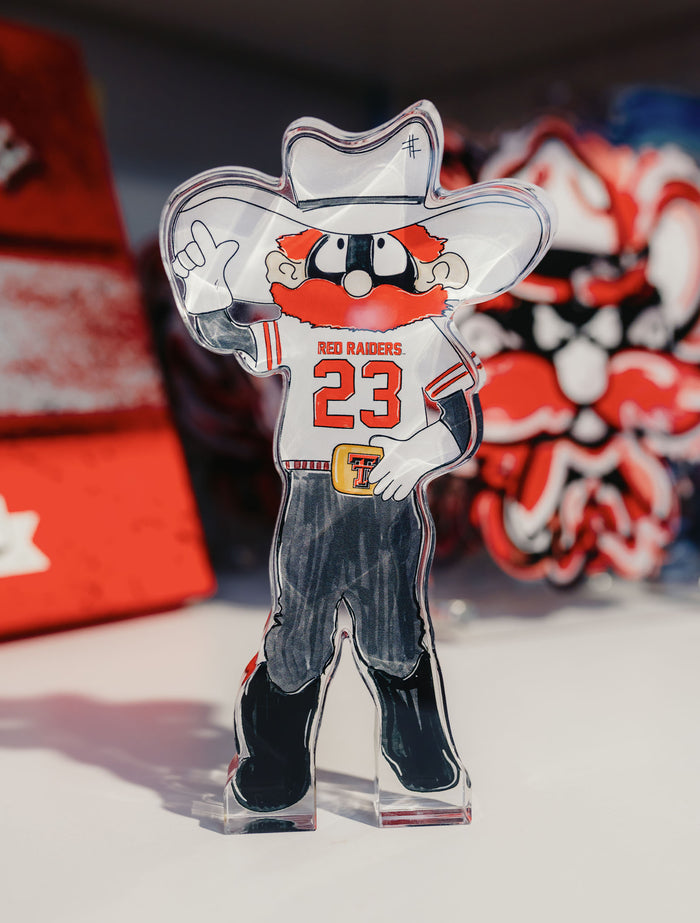 Tailgated Co. Texas Tech Raider Red acrylic shelfie standing on a shelf, with Raider Red giving the Guns Up in a RED RAIDERS #23 jersey