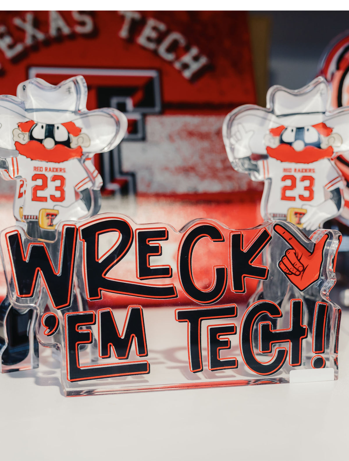 Texas Tech Wreck 'Em Tech acrylic shelfie displayed in front of two Raider Red acrylic shelfies