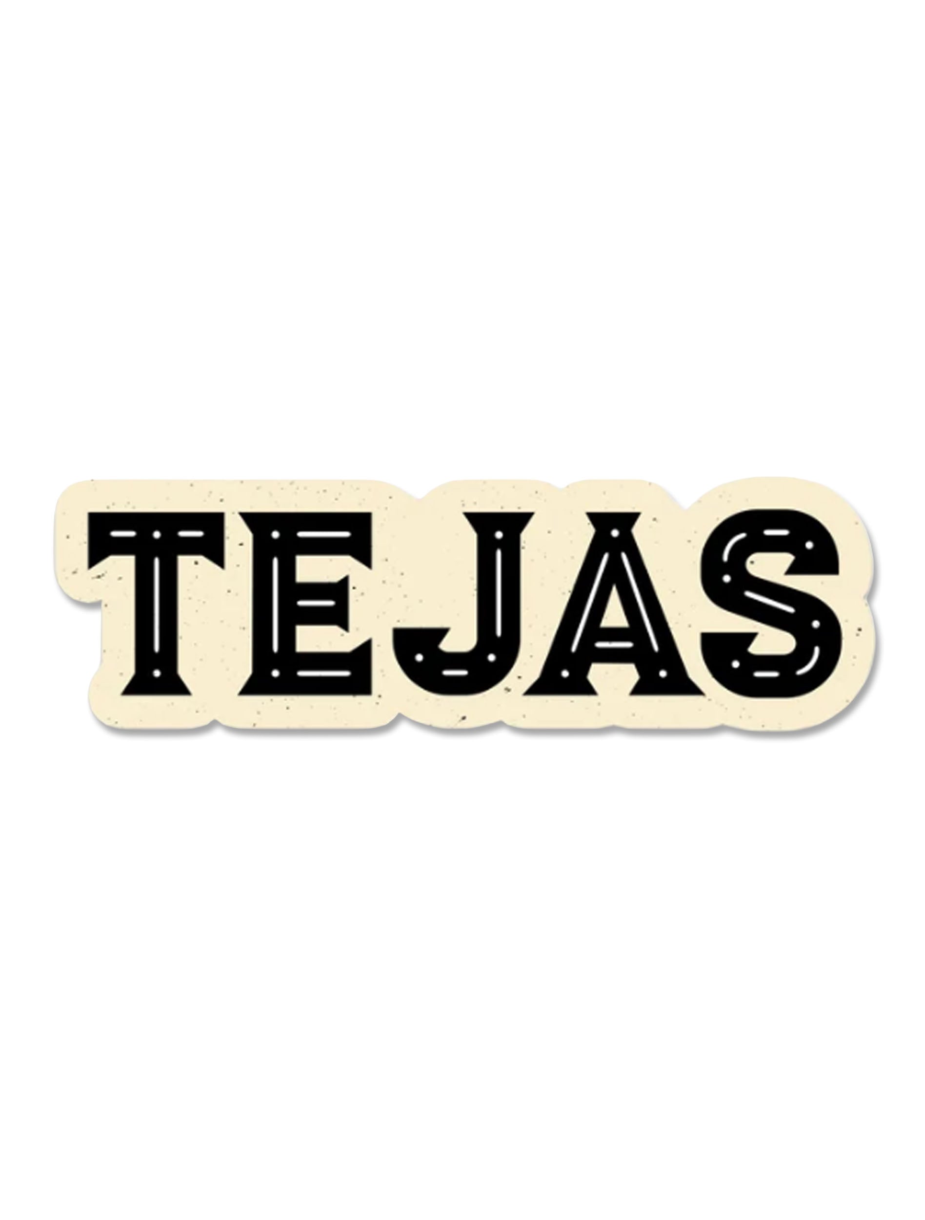 Vintage vinyl sticker reading "TEJAS" in bold black western lettering with inlaid line detail on a cream background