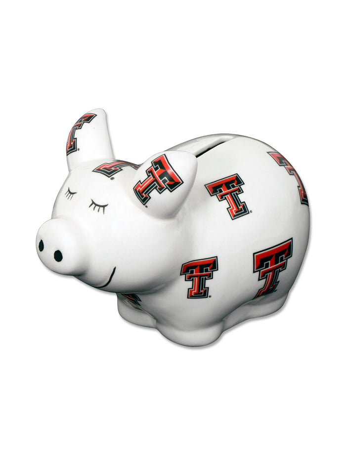 White ceramic pig shaped bank covered in red and black Double T marks, including on both ears, with painted lashes and a smile