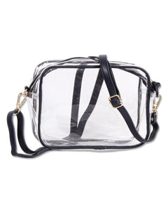 Clear crossbody purse with black trim and gold hardware carried on the slim black vegan leather strap