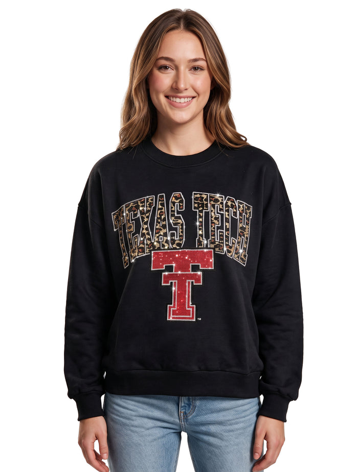 Model wearing the black Texas Tech crewneck sweatshirt with a rhinestone tan leopard print arch over a red Vault Double T
