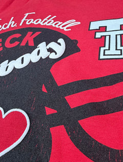 Close up of the raised white puff print lettering and the red heart on the helmet