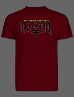 Front of the tee photographed in the dark, showing the arch lettering glowing green