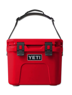 Front of the red Yeti Roadie 15 cooler with the carry strap raised