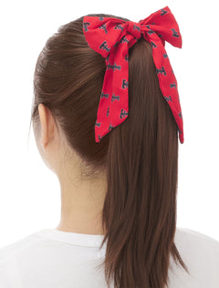 Texas Tech red bow scrunchie with an allover black Double T print, worn on a ponytail