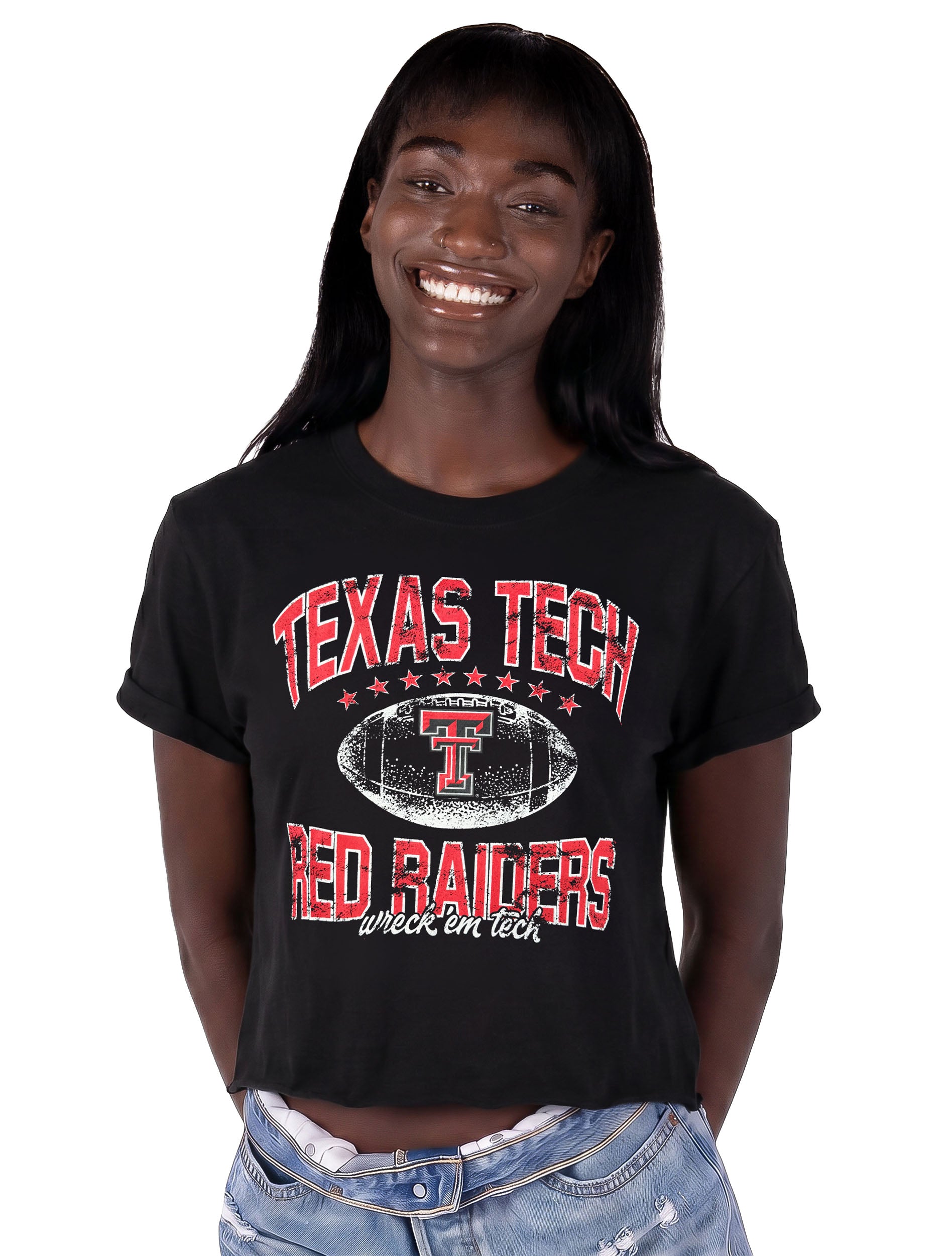 Model wearing the black ZooZatz Texas Tech Prime Time crop tee with distressed red TEXAS TECH and RED RAIDERS lettering around a white football with the Double T and Wreck 'Em Tech script