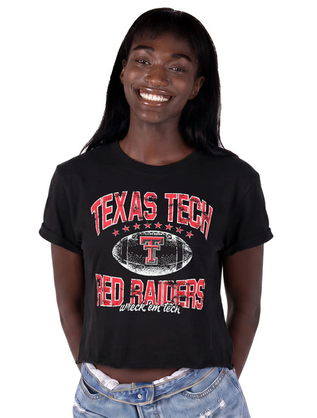 Model wearing the black ZooZatz Texas Tech Prime Time crop tee with distressed red TEXAS TECH and RED RAIDERS lettering around a white football with the Double T and Wreck 'Em Tech script