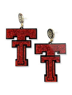 Pair of Texas Tech vintage Double T dangle earrings in red glitter acrylic over black, hanging from gold plated posts with the Brianna Cannon monogram